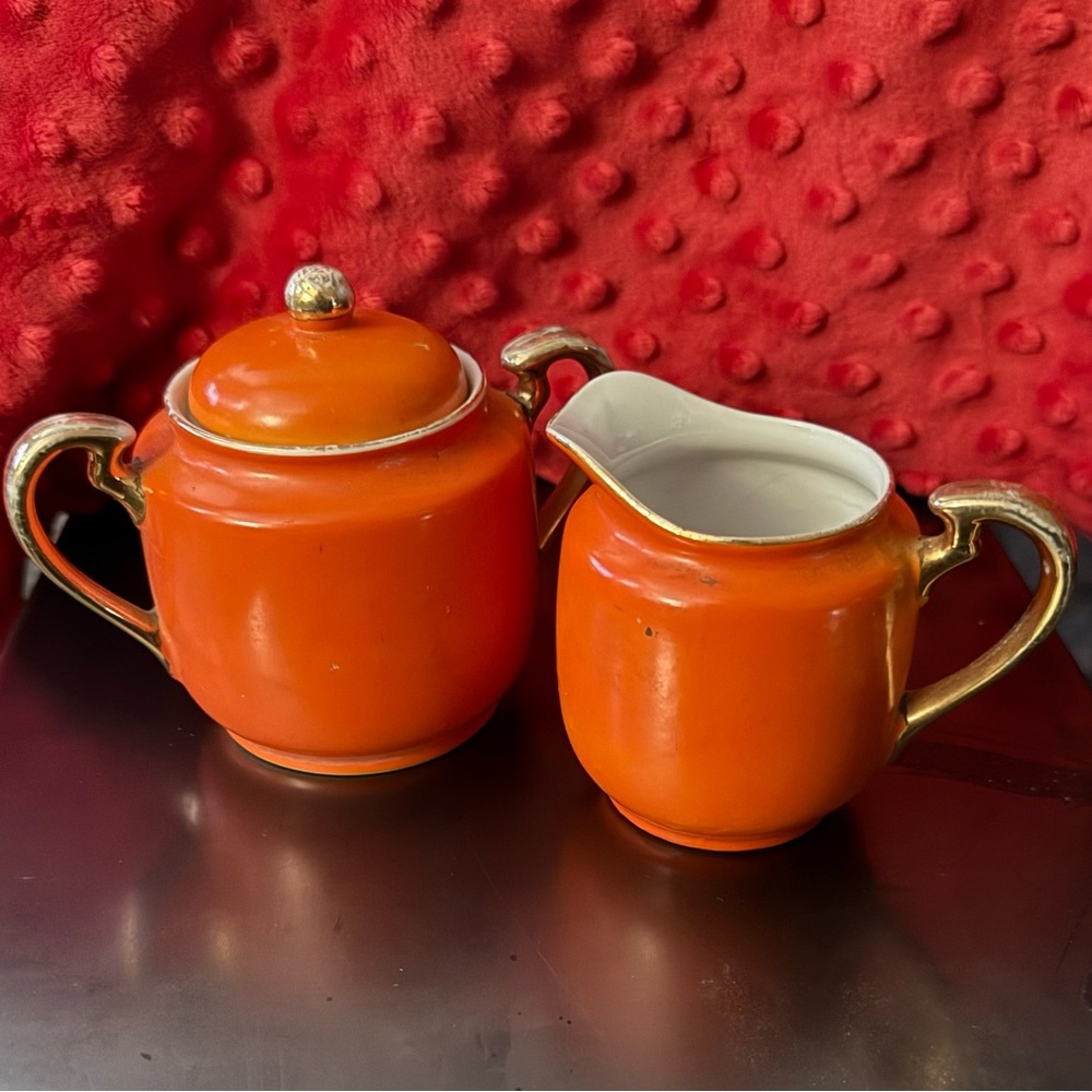 Gold castle sugar and creamer set.